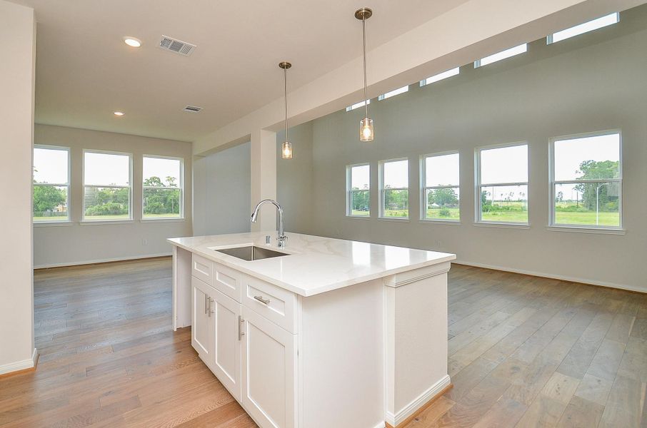 The huge island gives an extra space for seating to enjoy casual meals and also allows ample counter room. The huge island gives an extra space for seating to enjoy casual meals and also allows ample counter room.