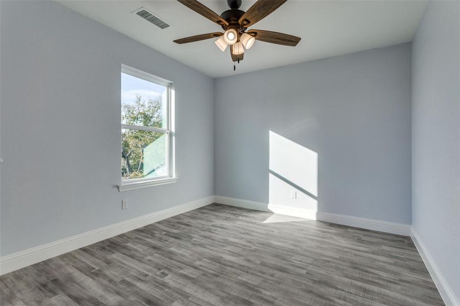 Spare room with ceiling fan and light wood-type flooring