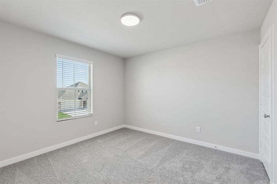 Bedroom in the Holden home plan by Trophy Signature Homes – REPRESENTATIVE PHOTO