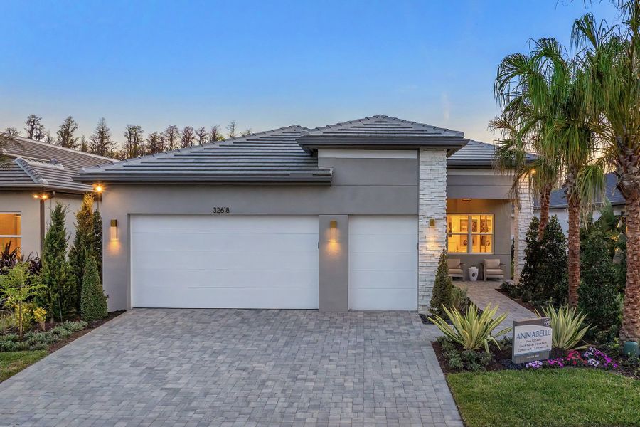 Front exterior of a new home in Valencia Ridge, Wesley Chapel, FL, highlighting curb appeal (Image 1).