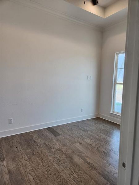 Empty room featuring dark hardwood / wood-style flooring