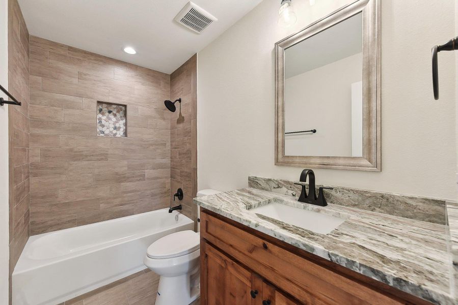 Upstairs Full bath featuring shower / bath combination, visible vents, toilet, and vanity