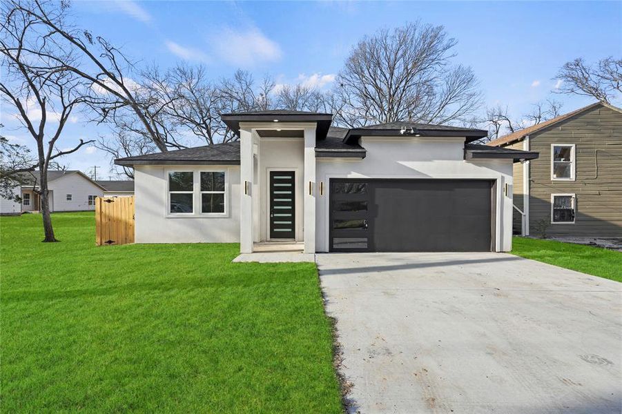 Prairie-style house with a front lawn and a garage