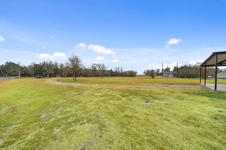 Beyond the gate, a long, scenic gravel driveway winds through mature timber, offering a peaceful transition from the outside world to your private homestead.