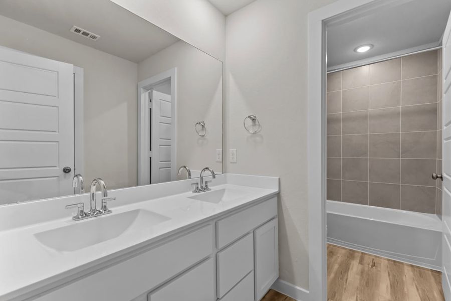 A bathroom with a tub sink and a shower.