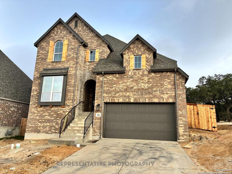 Front exterior of a new home in The Ranches at Creekside, Boerne, TX, highlighting curb appeal (Image 1). Front exterior of a new home in The Ranches at Creekside, Boerne, TX, highlighting curb appeal (Image 1).