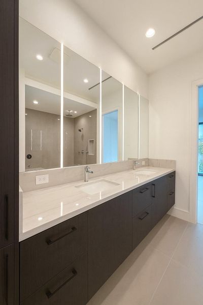 Lighted mirrors and cove lighting for spa ambiance.