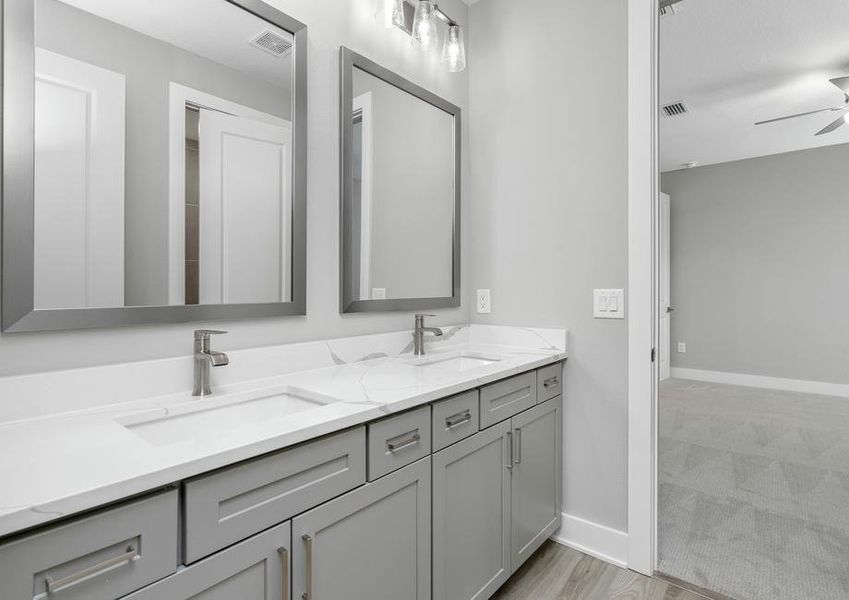 Large secondary bathrooms include beautiful cabinetry.