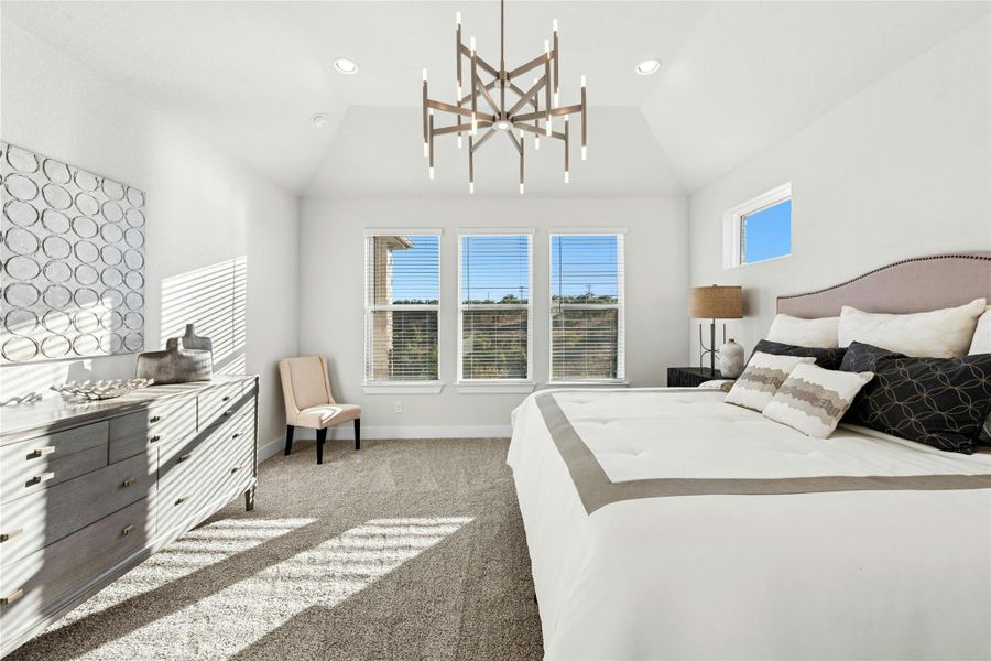 Bedroom featuring light colored carpet, a chandelier, recessed lighting, and vaulted ceiling Bedroom featuring light colored carpet, a chandelier, recessed lighting, and vaulted ceiling