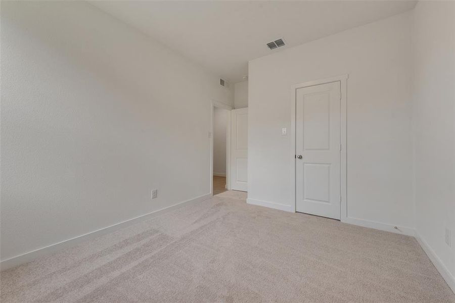 Unfurnished bedroom with light carpet