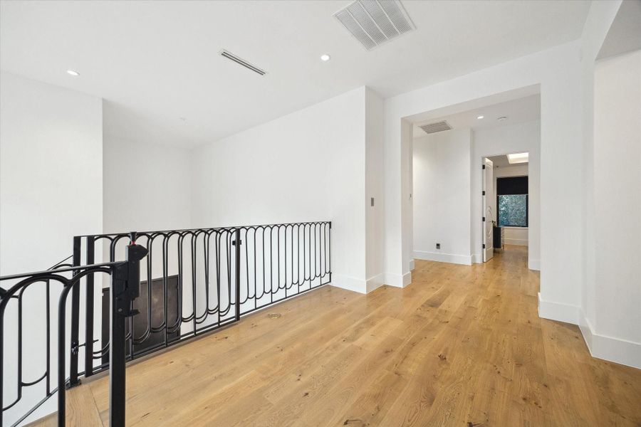 Second level landing providing access to the primary suite and guest bedrooms