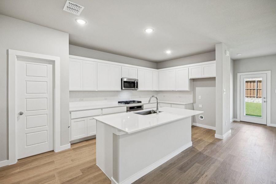 Kitchen in the Oscar home plan by Trophy Signature Homes – REPRESENTATIVE PHOTO Kitchen in the Oscar home plan by Trophy Signature Homes – REPRESENTATIVE PHOTO