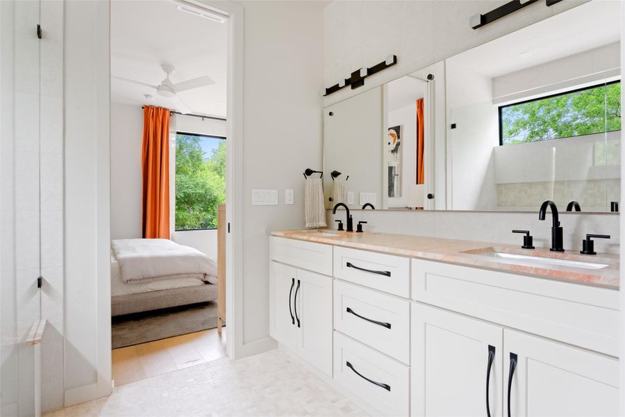 Full bathroom featuring plenty of natural light, a sink, and double vanity