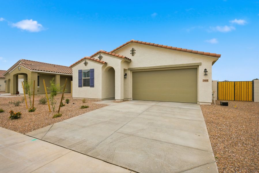 Front exterior of a new home in Bethany Grove, Glendale, AZ, highlighting curb appeal (Image 2). Front exterior of a new home in Bethany Grove, Glendale, AZ, highlighting curb appeal (Image 2).
