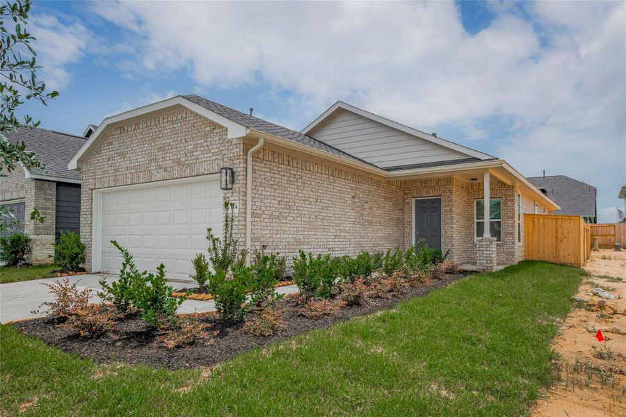 Front exterior of a new home in La Segarra, Brookshire, TX, highlighting curb appeal (Image 25). Front exterior of a new home in La Segarra, Brookshire, TX, highlighting curb appeal (Image 25).