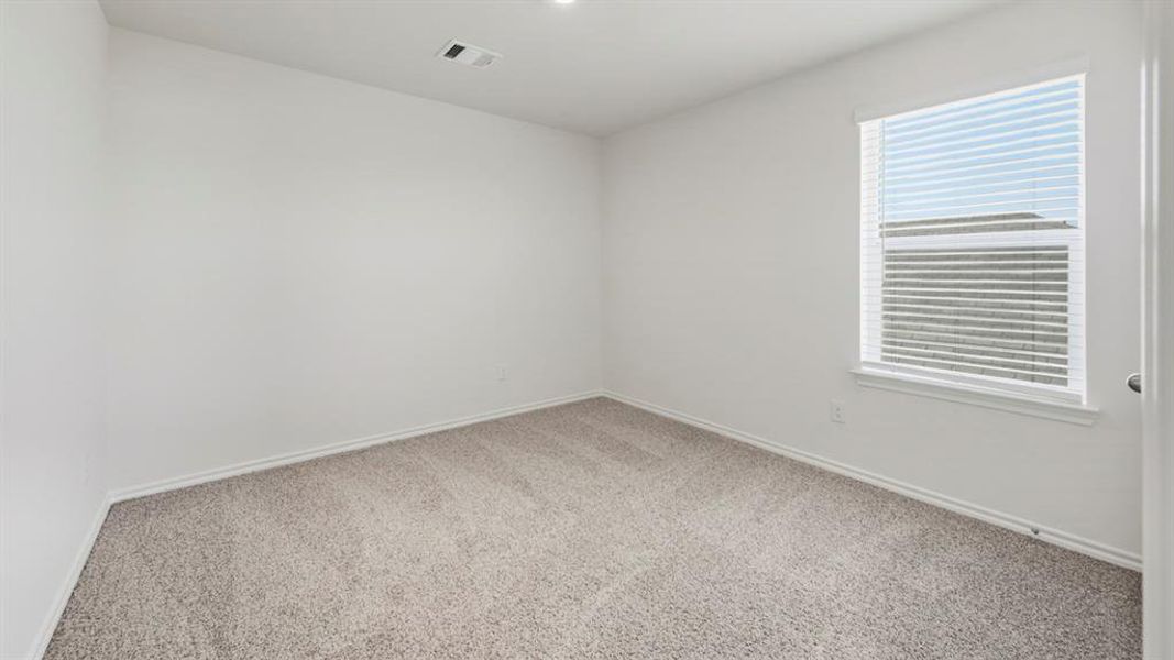 Carpeted spare room with baseboards