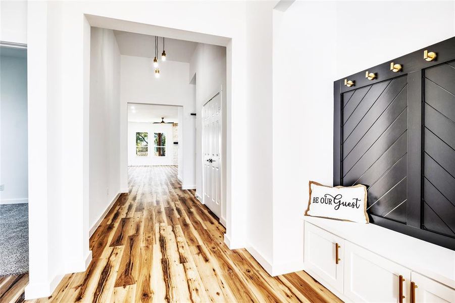 Corridor with light wood-style flooring and baseboards