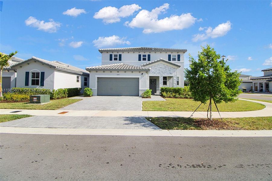 Front exterior of a new home in , Homestead, FL, highlighting curb appeal (Image 1). Front exterior of a new home in , Homestead, FL, highlighting curb appeal (Image 1).