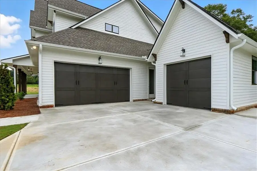 Front exterior of a new home in Old Town Estates, Dacula, GA, highlighting curb appeal (Image 26).