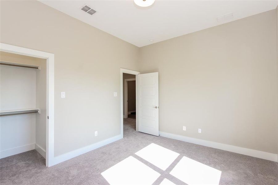 Unfurnished bedroom featuring light carpet