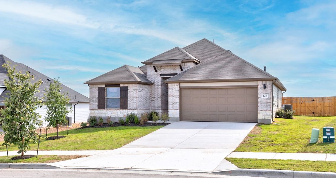 Front exterior of a new home in Prairie Winds, Hutto, TX, highlighting curb appeal (Image 18).