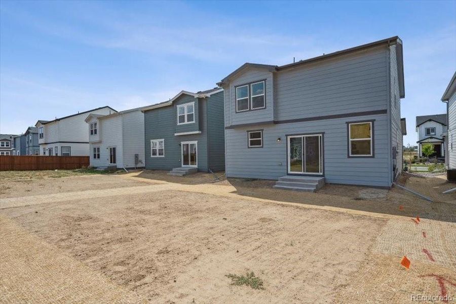 Front exterior of a new home in Farmlore, Brighton, CO, highlighting curb appeal (Image 14).