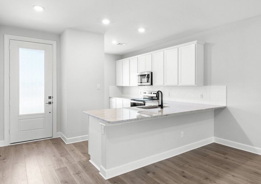 The kitchen of the Driftwood has sprawling granite countertops.