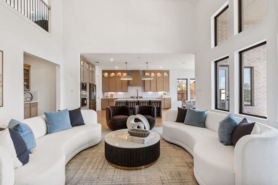 Architecturally striking living space with soaring ceilings and dramatic walls of windows that bathe the home in natural light