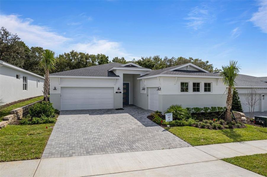 Front exterior of a new home in Cresswind at Hammock Oaks, Lady Lake, FL, highlighting curb appeal (Image 1).
