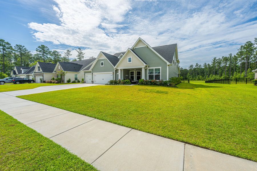 Front exterior of a new home in The Enclave at French Quarter Creek, Huger, SC, highlighting curb appeal (Image 2). Front exterior of a new home in The Enclave at French Quarter Creek, Huger, SC, highlighting curb appeal (Image 2).