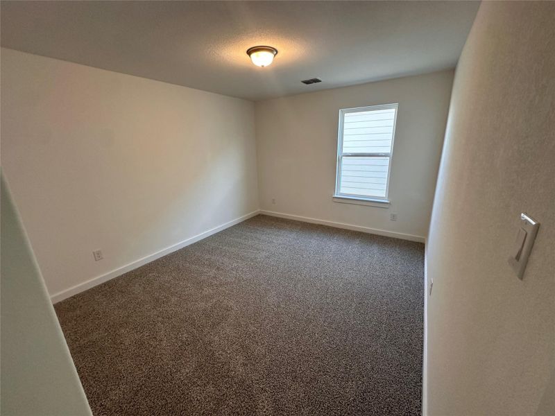 Carpeted empty room featuring baseboards Carpeted empty room featuring baseboards