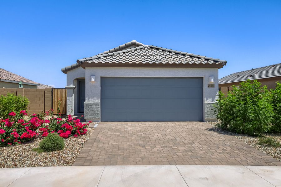 Front exterior of a new home in Asante Heritage | Active Adult, Surprise, AZ, highlighting curb appeal (Image 1). Front exterior of a new home in Asante Heritage | Active Adult, Surprise, AZ, highlighting curb appeal (Image 1).