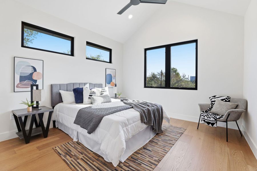 Bedroom featuring ceiling fan, light wood-type flooring, high vaulted ceiling, and recessed lighting Bedroom featuring ceiling fan, light wood-type flooring, high vaulted ceiling, and recessed lighting