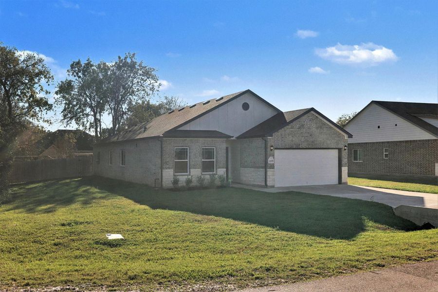Front exterior of a new home in Lake Conroe Hills, Willis, TX, highlighting curb appeal (Image 1).