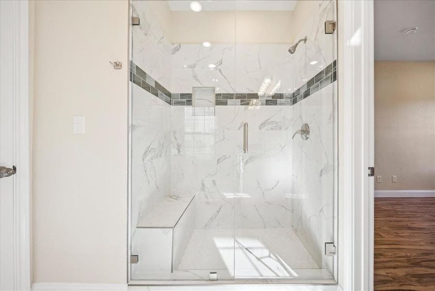 Bathroom featuring hardwood / wood-style flooring and a shower with door