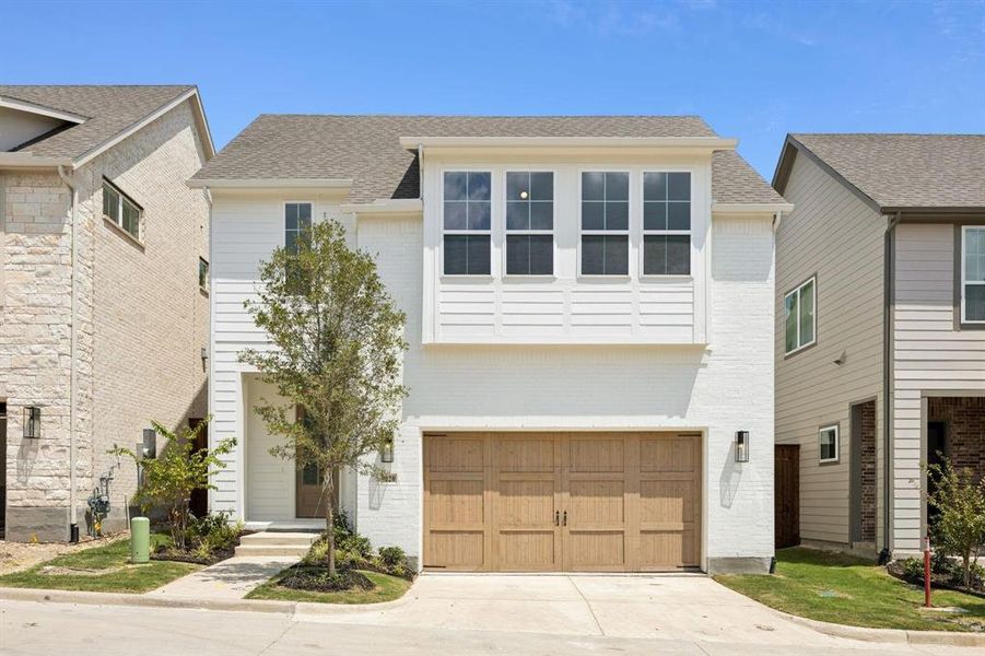 View of front of property featuring brick siding, an attached garage, a shingled roof, and concrete driveway View of front of property featuring brick siding, an attached garage, a shingled roof, and concrete driveway