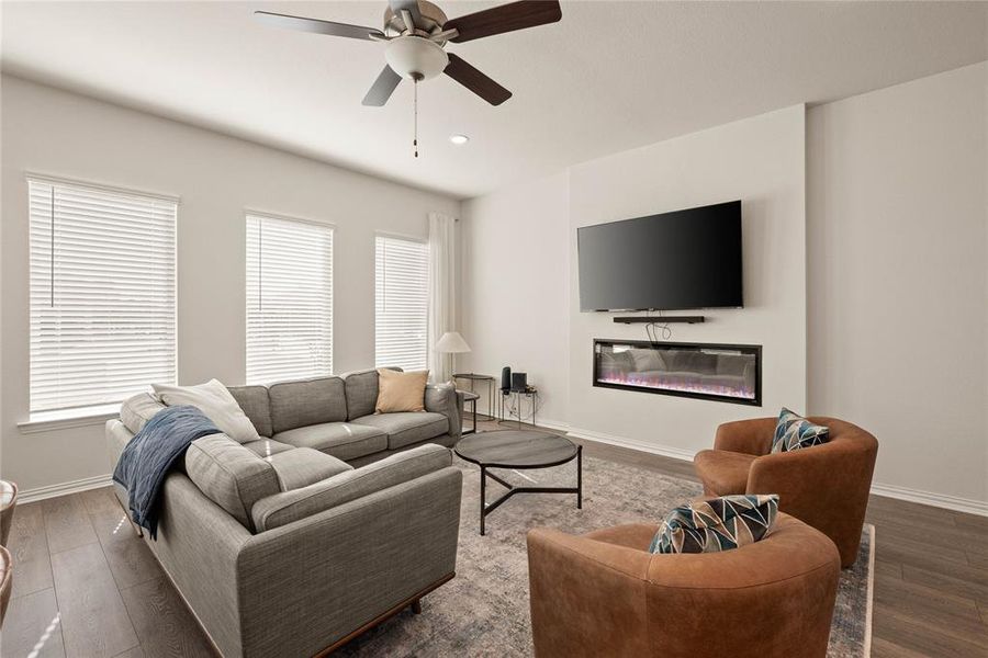 Living room featuring plenty of natural light, dark hardwood / wood-style floors, and ceiling fan