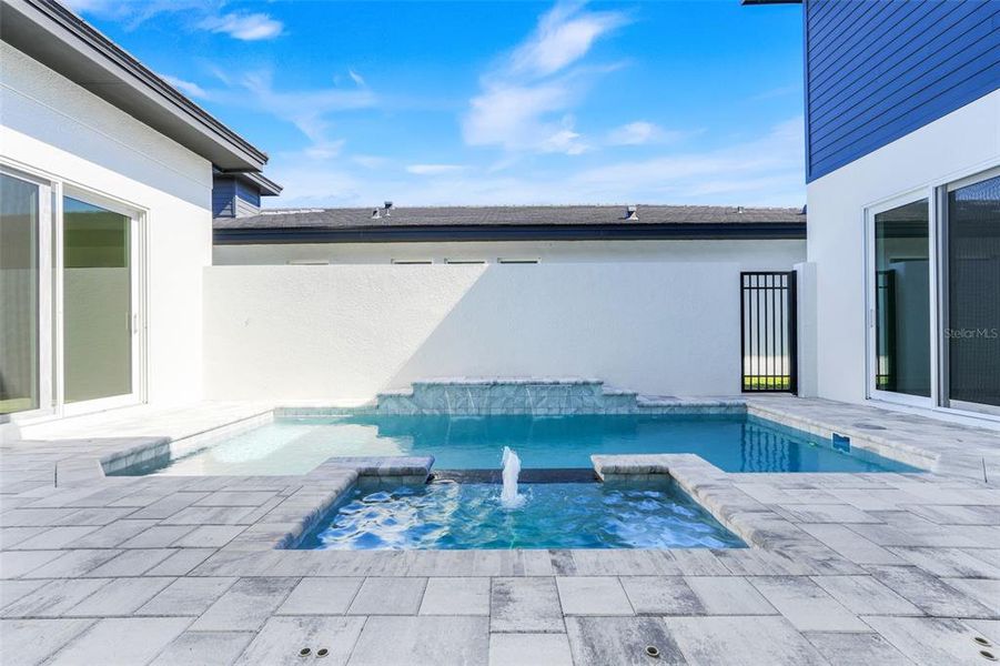 Exterior details and patio area of a home in Hampton Green at Providence, Davenport (Image 35).