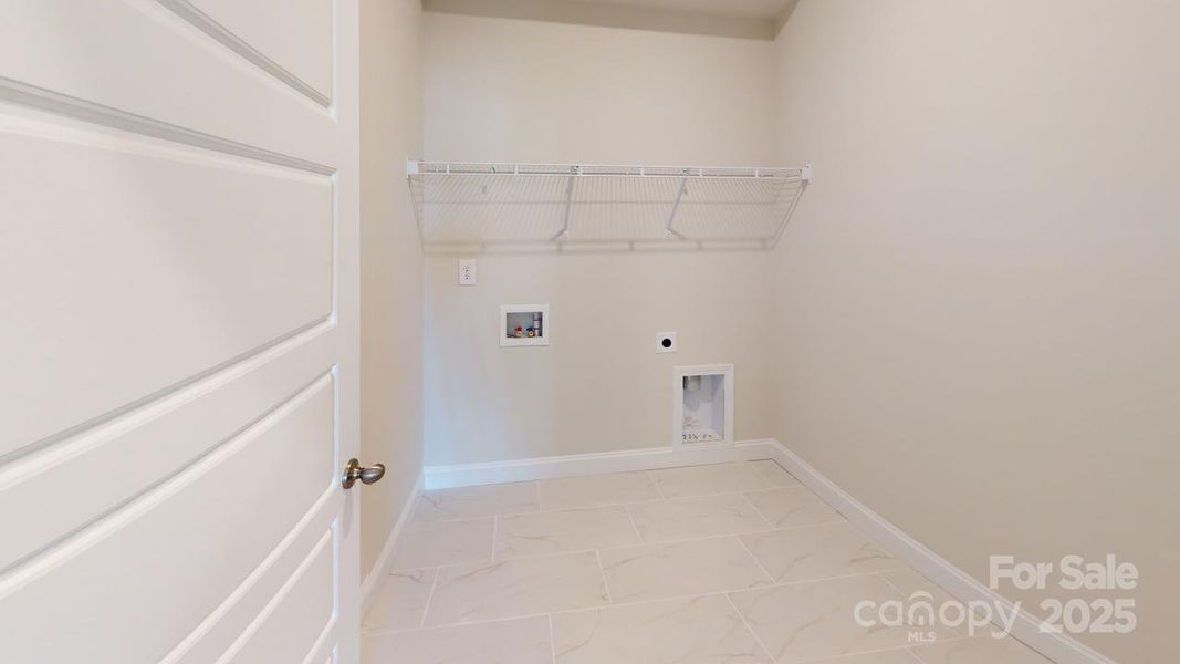 Main level laundry room - Photo is representative of a previous home built
