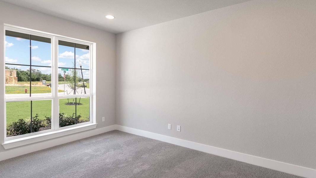 Carpeted empty room featuring baseboards and recessed lighting