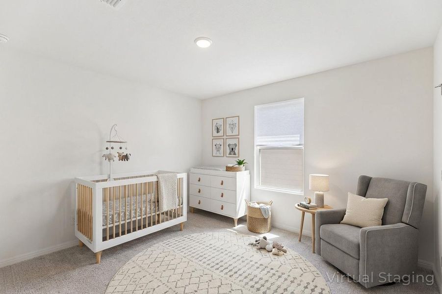 Bedroom featuring a crib and light carpet