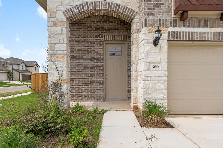 Property entrance featuring brick siding and stone siding Property entrance featuring brick siding and stone siding