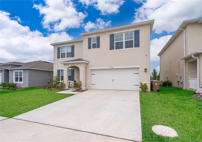 Front exterior of a new home in Kindred, Kissimmee, FL, highlighting curb appeal (Image 19).