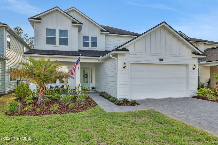 Front exterior of a new home in Settler's Landing at Nocatee, Ponte Vedra, FL, highlighting curb appeal (Image 29).