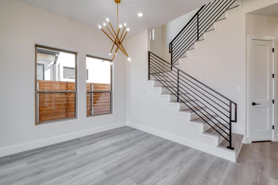 Staircase with recessed lighting, baseboards, and wood finished floors