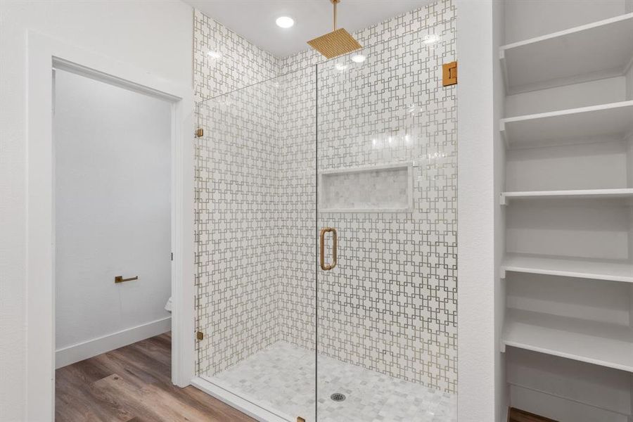 Bathroom featuring an enclosed shower, hardwood / wood-style flooring, and toilet