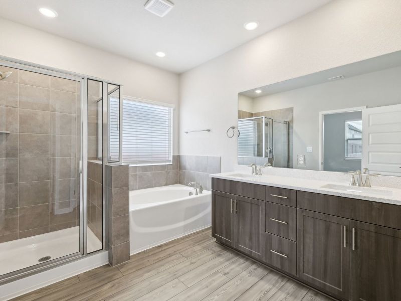 Live in luxury with a walk-in shower and a stand-alone bathtub in the primary bathroom.