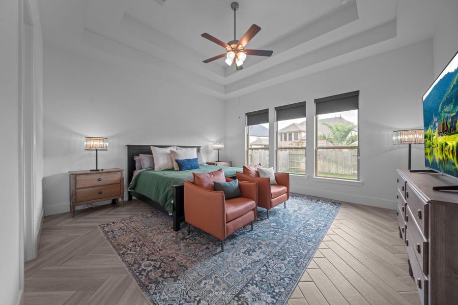 Incredibly spacious primary suite with tray ceiling, natural light, and backyard views. A comfortable retreat at the end of the day. Incredibly spacious primary suite with tray ceiling, natural light, and backyard views. A comfortable retreat at the end of the day.