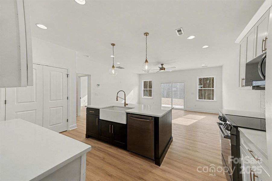 Open concept design features a kitchen that directly overlooks and connects to the family room, creating a spacious and inviting living area. Open concept design features a kitchen that directly overlooks and connects to the family room, creating a spacious and inviting living area.