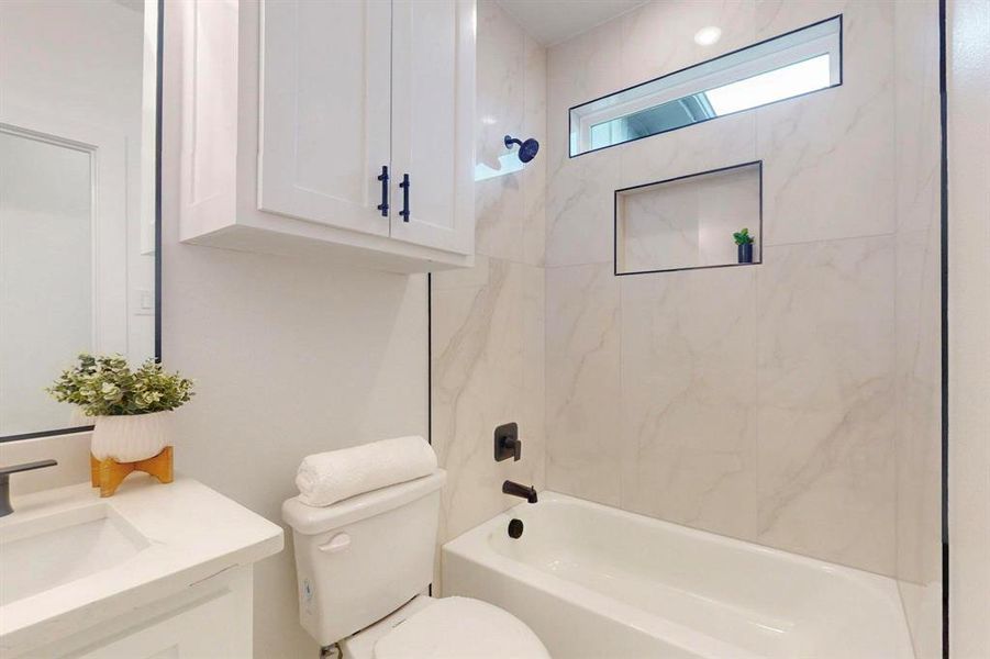 Bathroom with vanity, toilet, and bathing tub / shower combination Bathroom with vanity, toilet, and bathing tub / shower combination